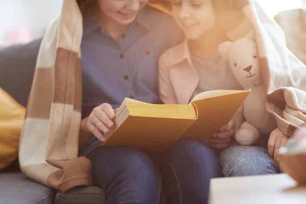 Closeup Portrait Two Sisters Reading Book Blanket Lit Warm Sunlight — Stock Photo, Image