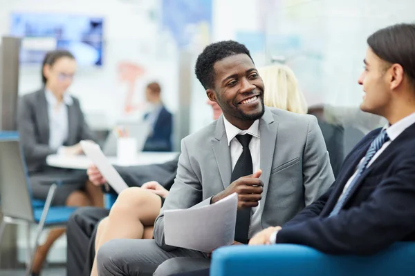 Portret Van Jonge Afrikaanse Zakenman Praten Met Collega Zittend Bank — Stockfoto