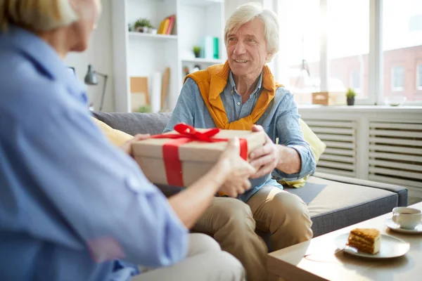 Portrait Contemporary Mature Couple Exchanging Gifts Home Focus Man Holding — Stock Photo, Image