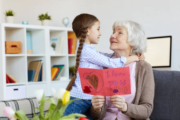 Portrait Cute Little Girl Hugging Grandma Giving Her Handmade Card — Stock Photo, Image