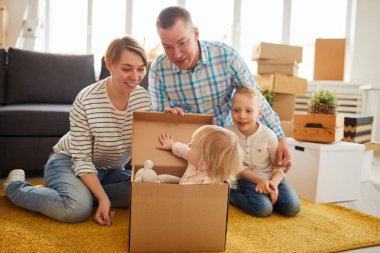 Karton kutunun içinde favori oyuncak ile saklanan güzel sarışın kızı: o anne bakıyor yeni düz onu bulundu