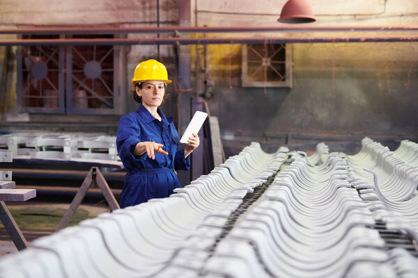 Portrait of female worker supervising production at factory, copy space