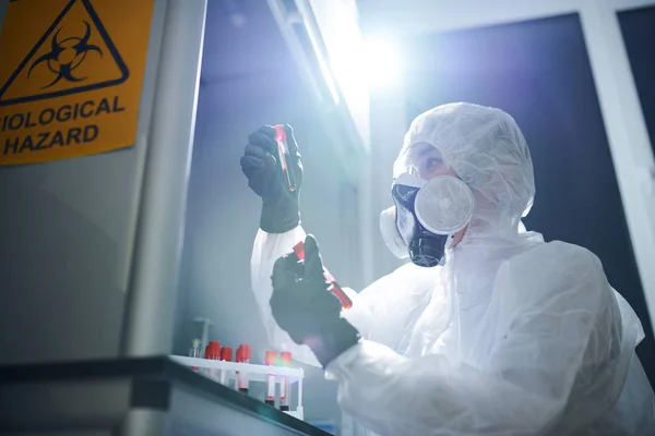 Concentrated Medical Scientist Biohazard Suit Respirator Safety Goggles Sitting Desk — Stock Photo, Image