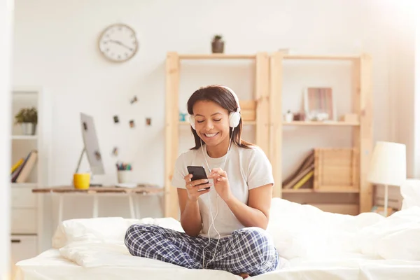 Portrait Young Mixed Race Woman Using Smartphone Sitting Bed Lit — Stock Photo, Image