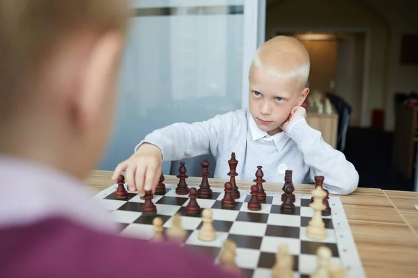 Blonde Schoolboy Making Chess Move Looking Seriously Confidently Eyes Opponent — Stock Photo, Image