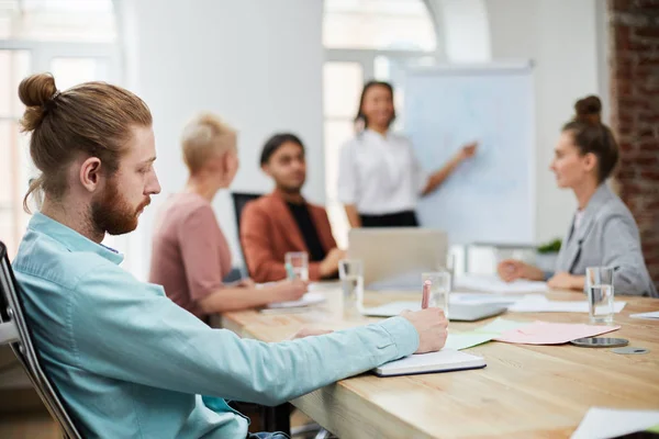 Side View Portrait Bearded Young Man Taking Notes Business Meeting — Stock Photo, Image