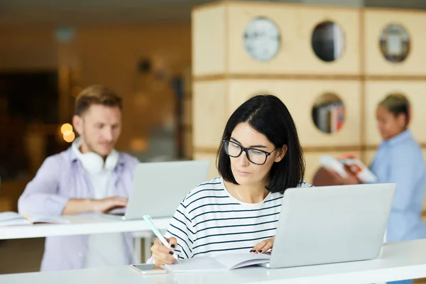 Serious Busy Female University Student Eyeglasses Sitting Table Using Laptop — Stock Photo, Image