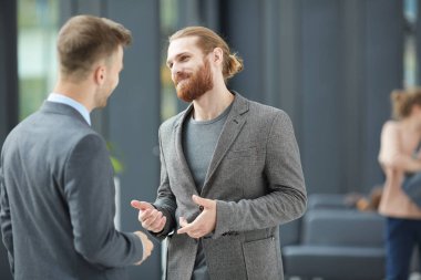 İş ortağı ile konuşurken ceketgesturing elleri İçerik yakışıklı sakallı yöneticisi