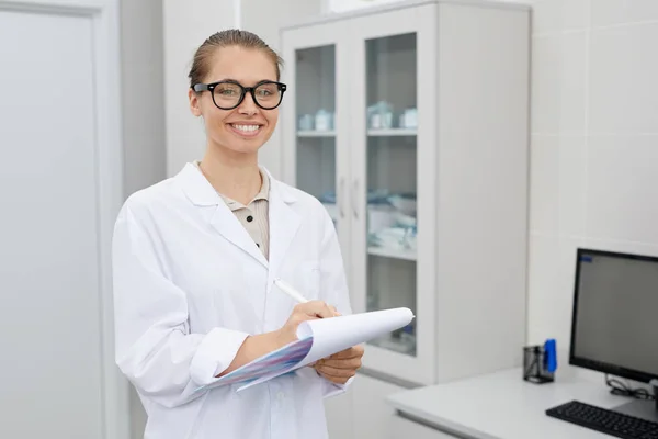 Talia Się Portret Całkiem Kobiecej Lekarza Trzymając Schowek Uśmiechając Się — Zdjęcie stockowe