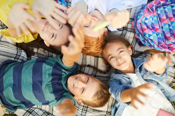 Four Smiling Teenage School Friends Lying Grass Park School Having — Stock Photo, Image