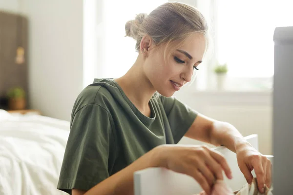 Mooie Jonge Huisvrouw Zittend Door Open Lade Terwijl Het Doen — Stockfoto