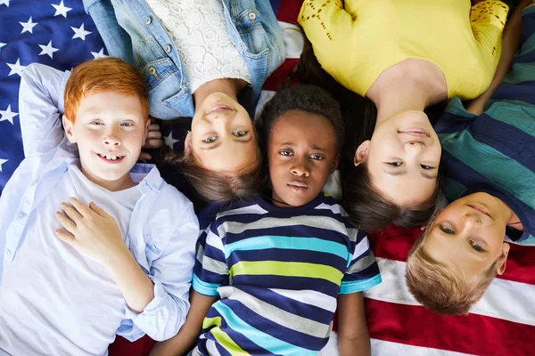 High Angle View Content Interracial American Children Lying American Flag Royalty Free Stock Images