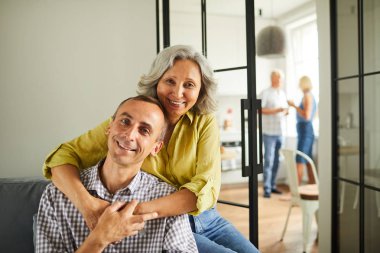 Evde kanepede oturan mutlu olgun çift portresi, kopya alanı