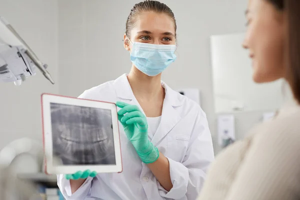 Klinikte Konsültasyon Sırasında Hastaya Diş Röntgeni Görüntüsü Gösteren Genç Kadın — Stok fotoğraf