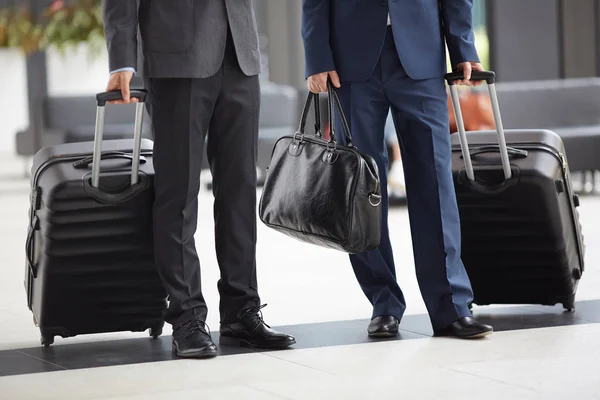 Close Unrecognizable Businessmen Formal Suits Holding Luggage Standing Airport Hall — Stock Photo, Image