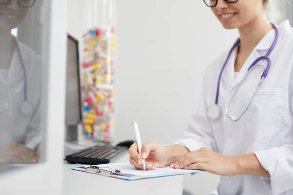 Mid Section Portrait Smiling Female Doctor Writing Clipboard While Sitting — Stock Photo, Image