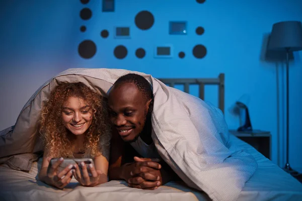 Portrait Carefree Mixed Race Couple Looking Smartphone Screen Smiling While — Stock Photo, Image