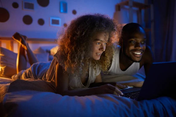 Portrait Young Mixed Race Couple Using Laptop Smiling While Lying — Stock Photo, Image
