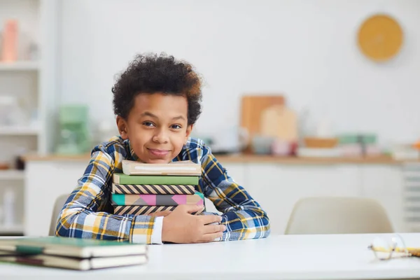 Portrait Cute African American Boy Holding Stack Books While Sitting — Stock Photo, Image