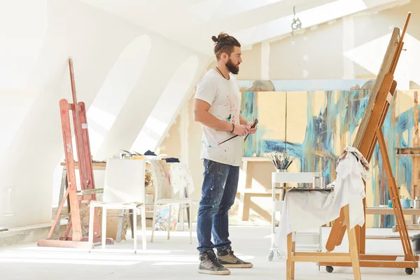 Full Length Portrait Contemporary Male Artist Looking Painting While Standing — Stockfoto