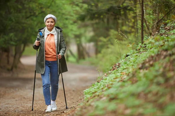 Full Length Portrait Active Senior Woman Walking Camera Nordic Poles — Stock Photo, Image