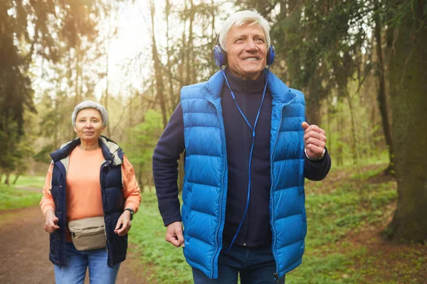 Front View Portrait Active Senior Couple Running Forest Focus Smiling — Stock Photo, Image