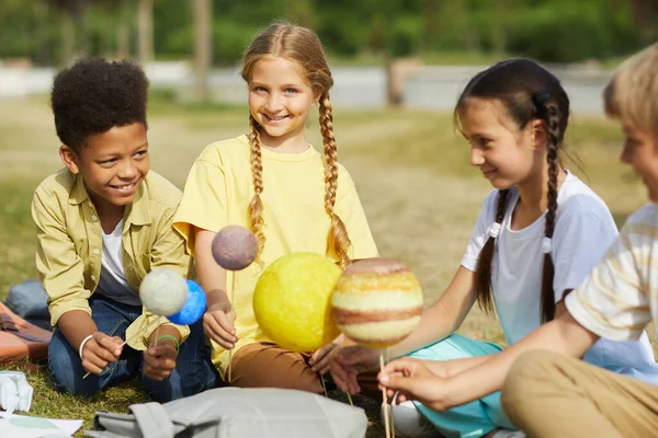 Multi Ethnic Group Kids Sitting Green Grass Holding Model Planets — Stock Photo, Image