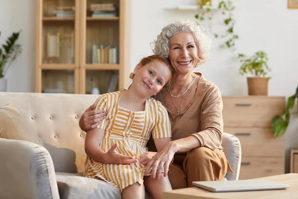 Warm Toned Portrait Smiling Senior Woman Embracing Cute Granddaughter While — Stock Photo, Image