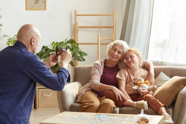 Warm Toned Portrait Senior Man Taking Smartphone Photo Wife Granddaughter — Stock Photo, Image