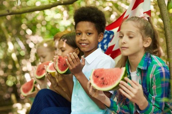Multi Ethnic Group Kids Eating Watermelon Sitting Row While Playing — Stock Photo, Image