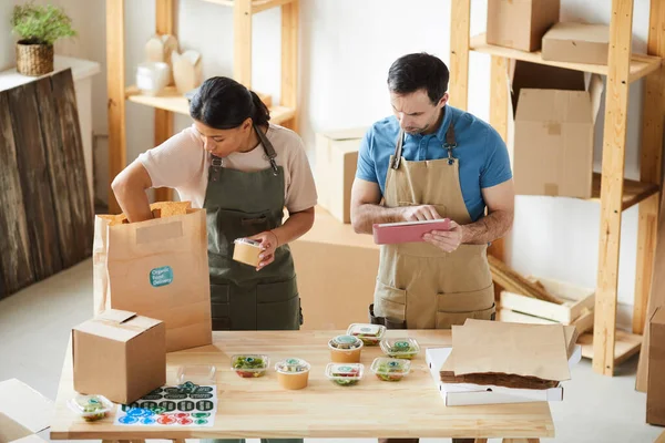 High Angle View Two Workers Wearing Aprons Packaging Orders Wooden — Stock Photo, Image