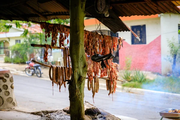 Original Caribbean food on the roadside in the Dominican Republic. Smoked pork, morcillas and longanizas