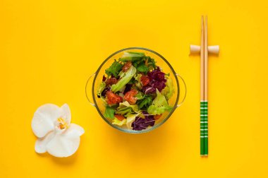 Somon salata Poke orkide sarı zemin üzerine. Ev yapımı yemek. Sağlıklı beslenme, kopya alanı, closeup kavramı.