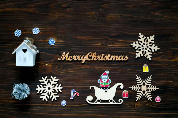 Christmas and New Year\'s decor. Decorative wooden snowflakes and Christmas decorations on wooden background, concept of New Year\'s