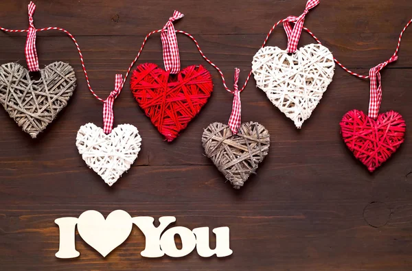 Love or Valentines Day concept. Wooden background with hearts. Flat lay, top view, copy space.