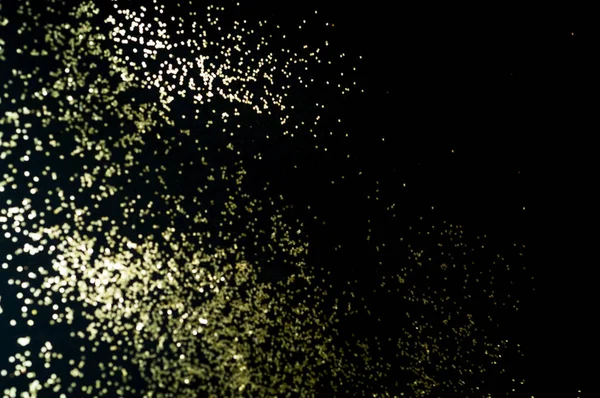 Black background with golden sparkles. Blurred  effect. Concept for festive background