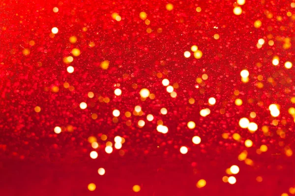 Decoração de Natal ou Ano Novo. Fundo vermelho com brilhos. Desfoque — Fotografia de Stock