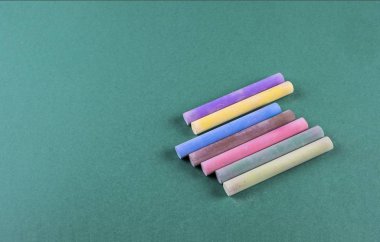 yeşil arka plan üzerinde renkli tebeşir görünümü yukarıdan