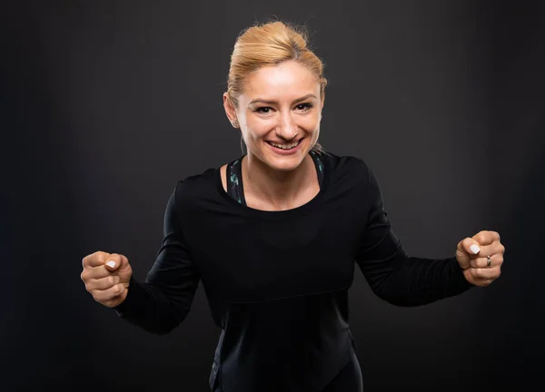 Portrait Gym Female Trainer Making Winner Gesture Black Background — Stock Photo, Image