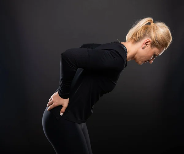 Retrato Una Entrenadora Gimnasia Conteniéndose Como Herida Sobre Fondo Negro —  Fotos de Stock