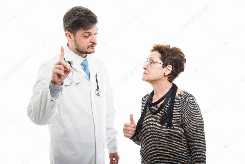 Male doctor and senior female patient showing like and number one on white background