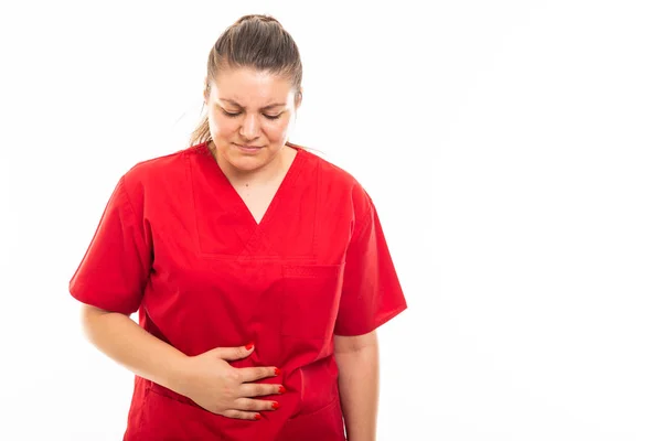 Portrait Young Medical Nurse Wearing Red Scrub Showing Stomachache Gesture — Stock Photo, Image