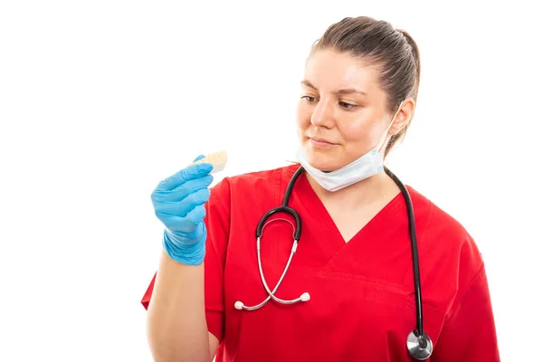 Portrait Young Medical Nurse Wearing Red Scrub Looking Dentures Isolated — Stock Photo, Image