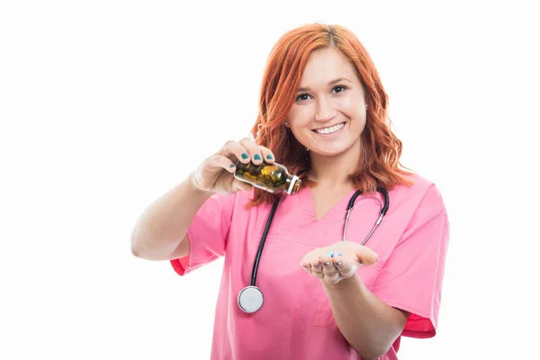 Portrait Young Female Doctor Stethoscope Emptying Bottle Pills Isolated White — Stock Photo, Image