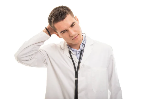 Portrait of young handsome doctor holding head like hurting — Stock Photo, Image