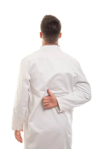 Vista posterior del joven médico mostrando como gesto — Foto de Stock