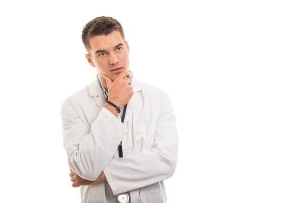 Portrait of young handsome doctor posing like thinking — Stock Photo, Image