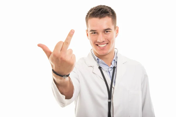 Portrait of young handsome doctor showing middle finger — Stock Photo, Image