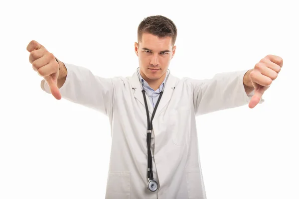 Portrait of young handsome doctor showing double dislike gesture — Stock Photo, Image