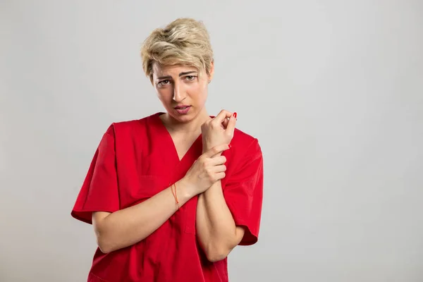 Portrait Young Attractive Female Nurse Holding Hurting Wrist Grey Background — Stock Photo, Image